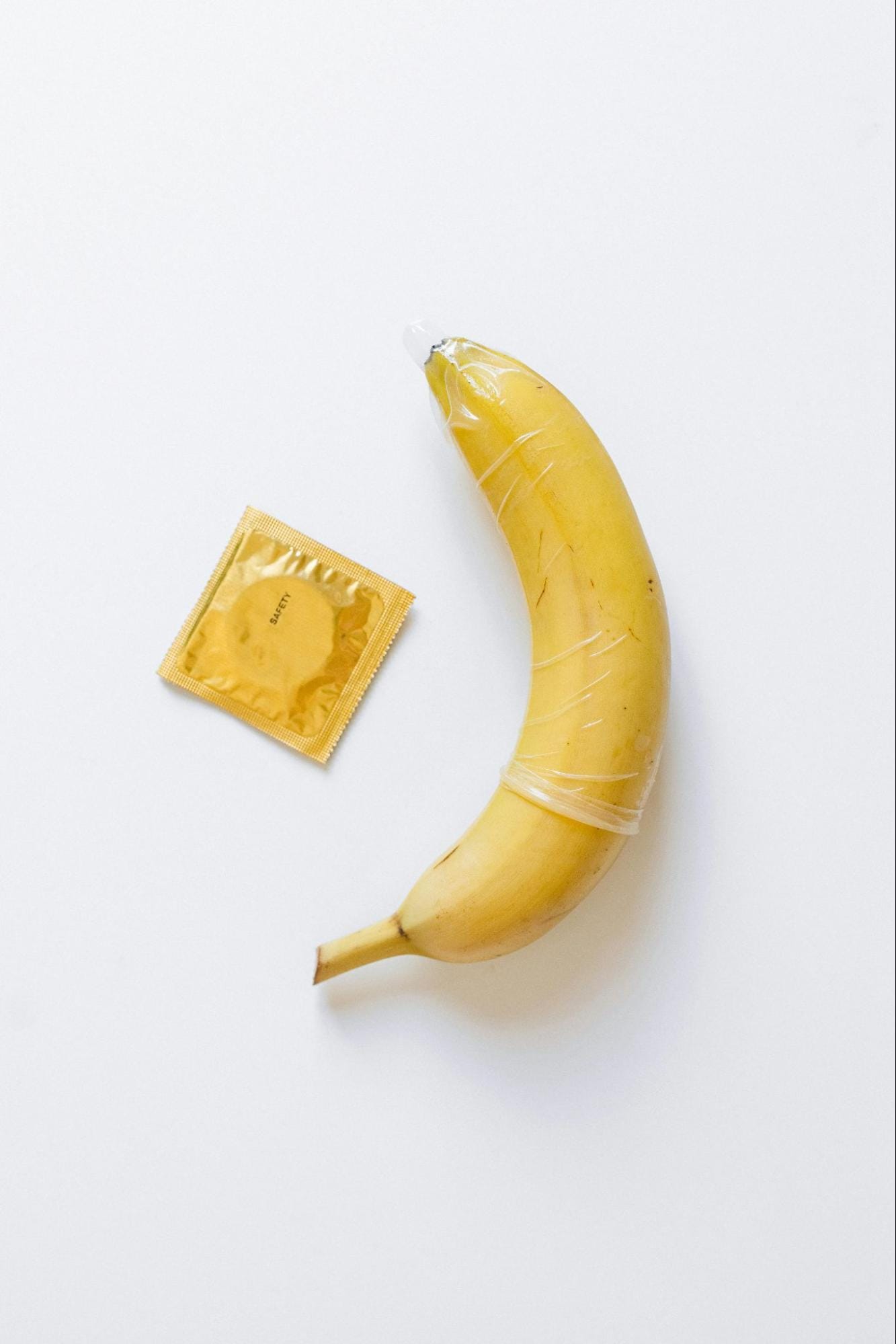 A banana and a condom on a table