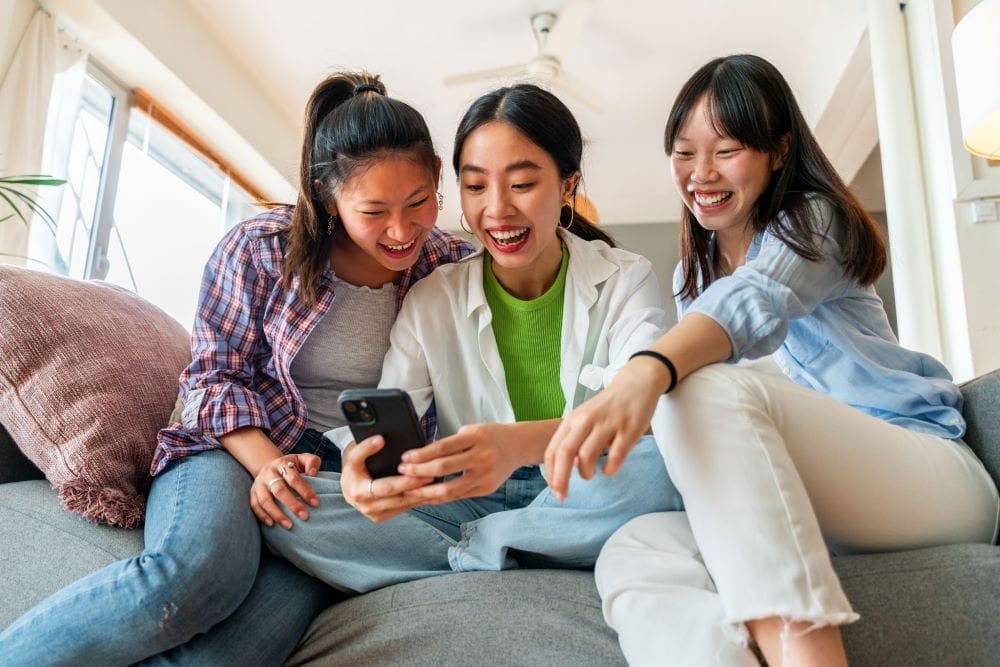 A woman reading the label of a supplement for women with friends.